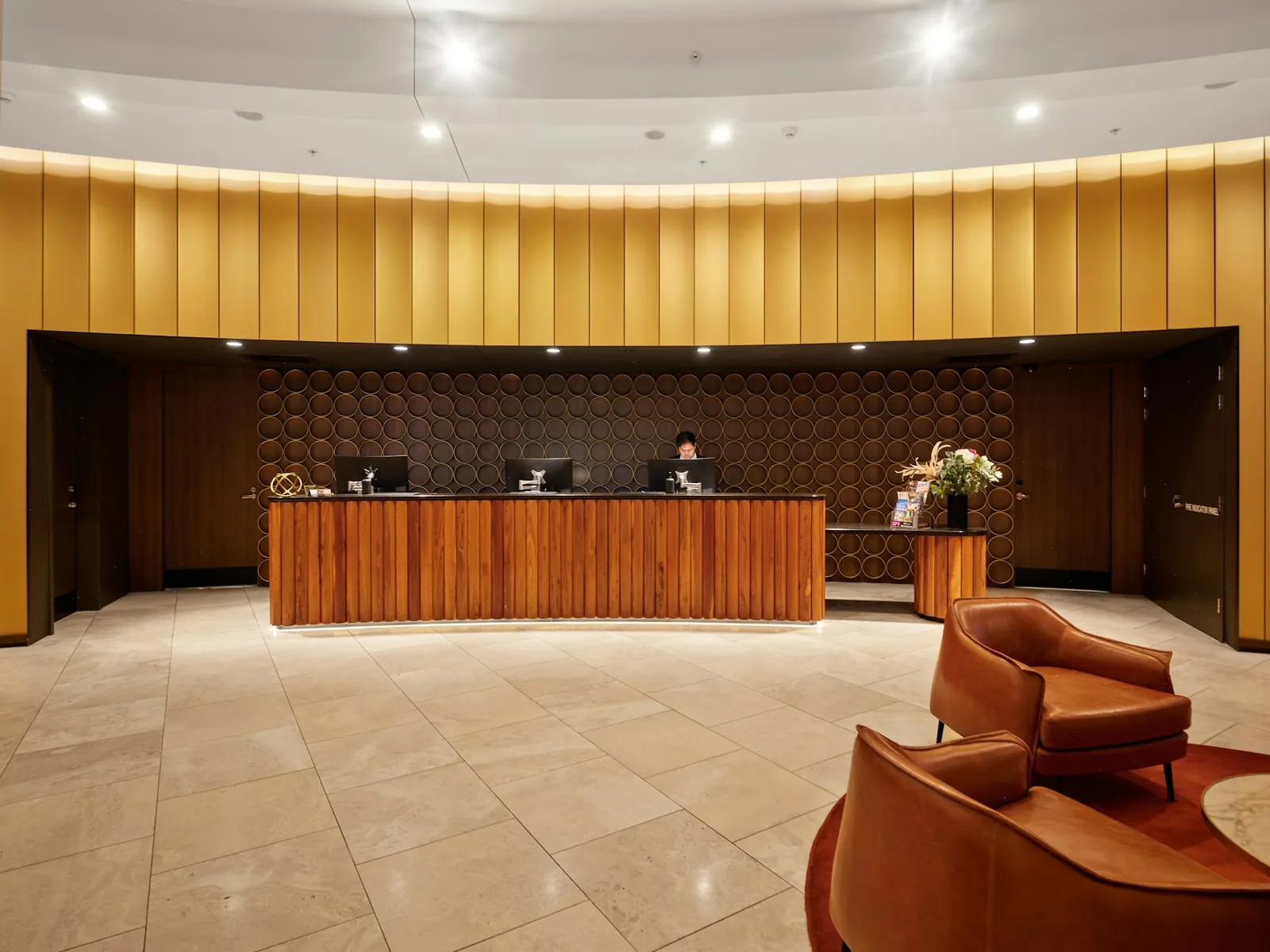 Hotel lobby with the reception desk and lounge chairs