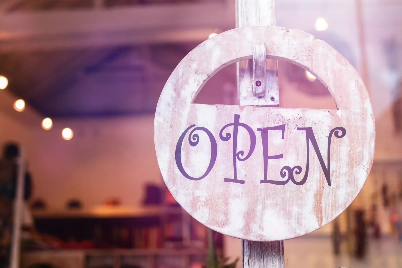 Open sign hanging on the door of a small local shop