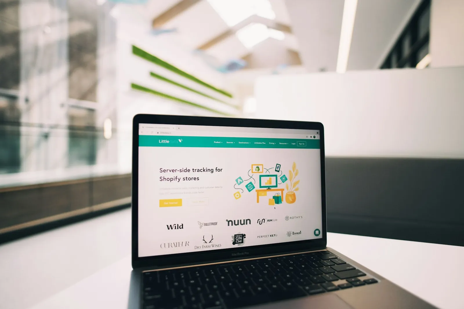 Laptop displaying a business website in a bright workspace